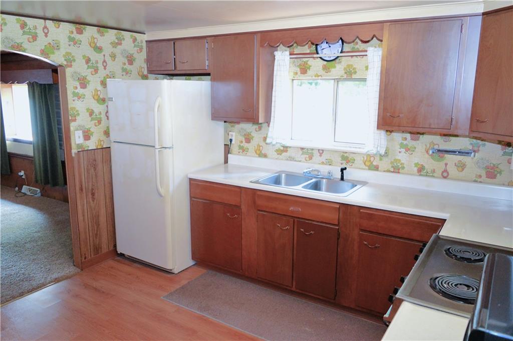 171 Medical Center Road Chicora, PA 16025 - Photo 3 of 15 a kitchen with a refrigerator sink and cabinets