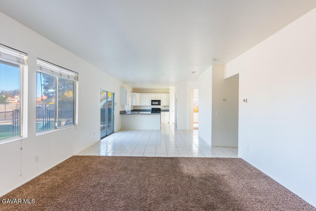 38318 Wakefield Place Palmdale, CA 93551 - Photo 11 of 33 a view of a living room hardwood floor and a kitchen