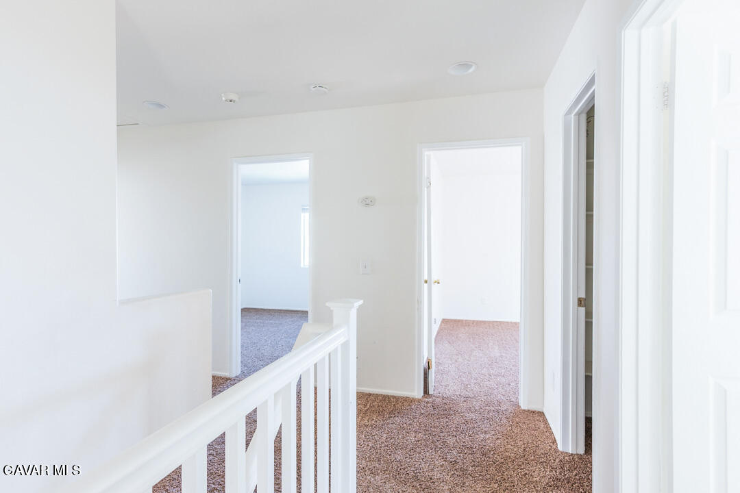 38318 Wakefield Place Palmdale, CA 93551 - Photo 14 of 33 a view of a hallway with an entryway door