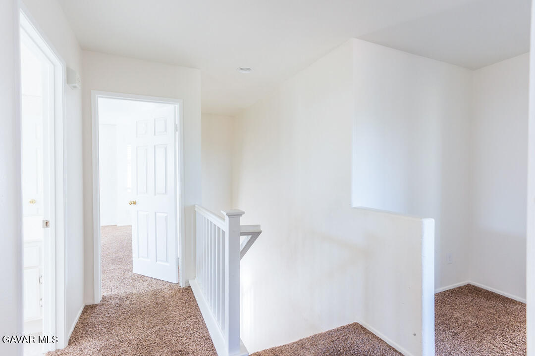 38318 Wakefield Place Palmdale, CA 93551 - Photo 15 of 33 a view of a hallway with a white walls