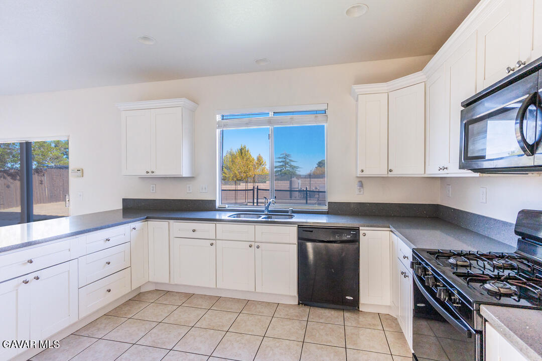 38318 Wakefield Place Palmdale, CA 93551 - Photo 9 of 33 a kitchen with white cabinets appliances and a sink