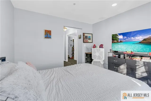 a bedroom with a bed and a flat screen tv