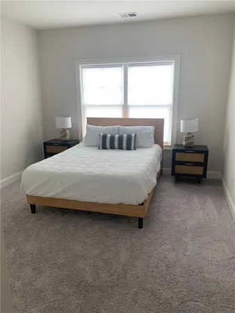 a bedroom with a bed and window