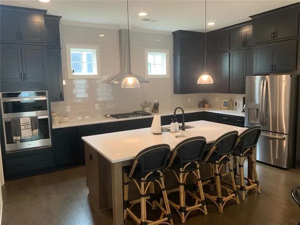 a kitchen with a sink appliances and cabinets