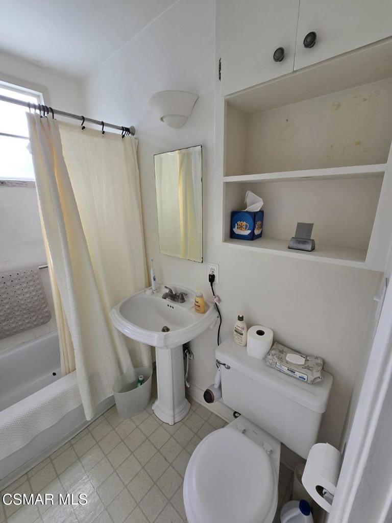 17526 Miranda Street Encino, CA 91316 - Photo 15 of 28 a bathroom with a sink a toilet and a shower