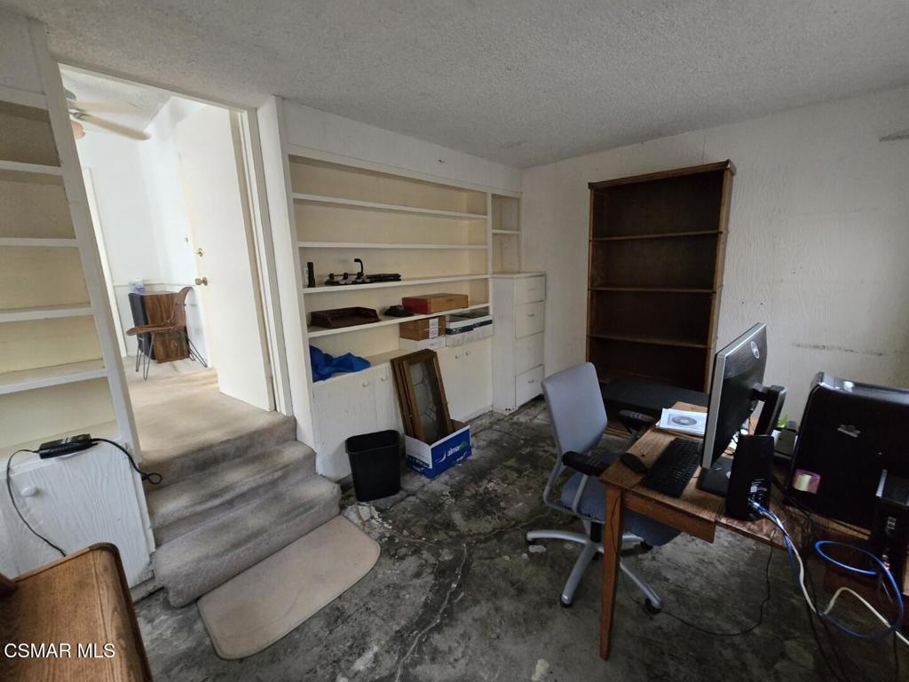 17526 Miranda Street Encino, CA 91316 - Photo 16 of 28 a room with furniture a rug and white walls