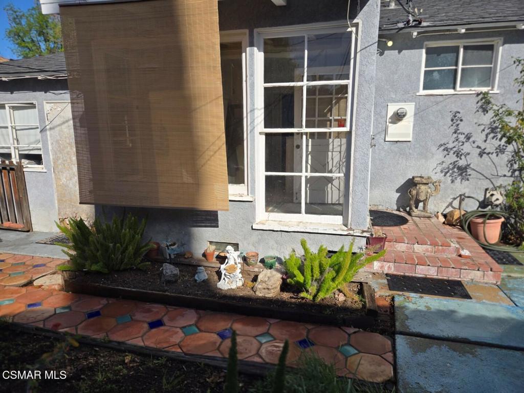 17526 Miranda Street Encino, CA 91316 - Photo 25 of 28 a front view of a house with potted plants