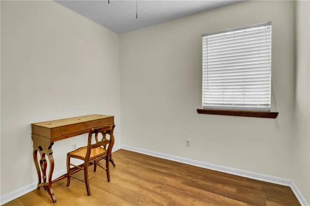 a view of a workspace with furniture and wooden floor