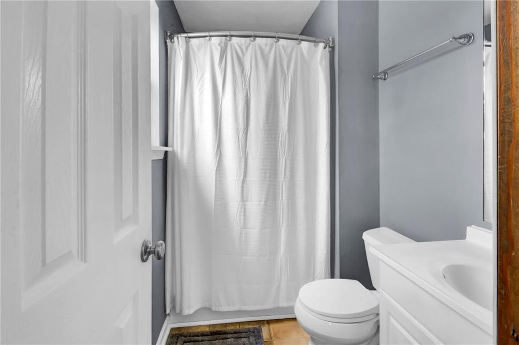 4947 Holbrook Circle Northwest Duluth, GA 30096 - Photo 15 of 26 a bathroom with a toilet and a shower curtain
