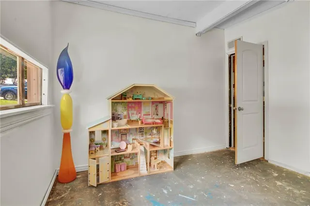 a view of a room with baby bed and windows