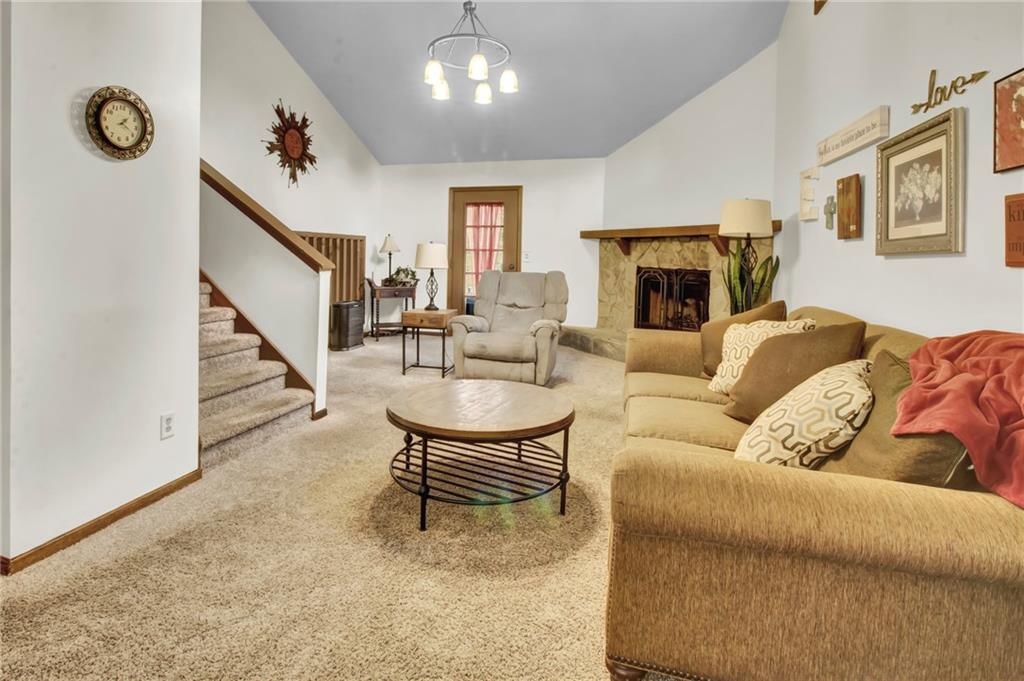 4947 Holbrook Circle Northwest Duluth, GA 30096 - Photo 4 of 26 a living room with furniture a fireplace and a flat screen tv