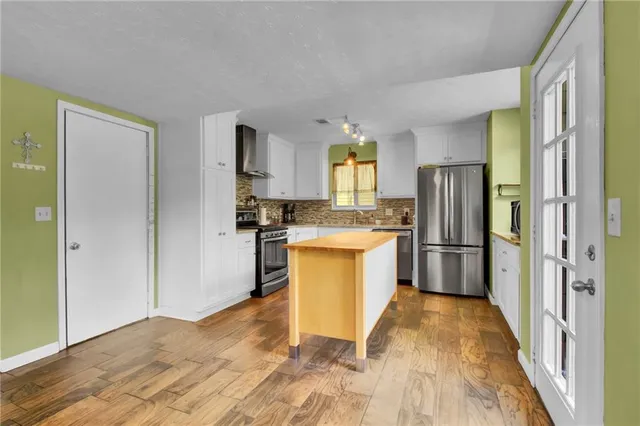 a kitchen with a refrigerator a stove top oven a sink and dishwasher
