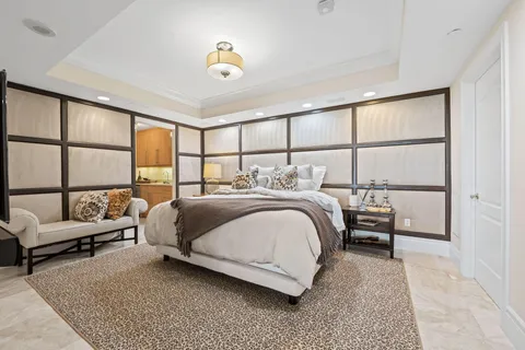 a bedroom with a bed couch and window