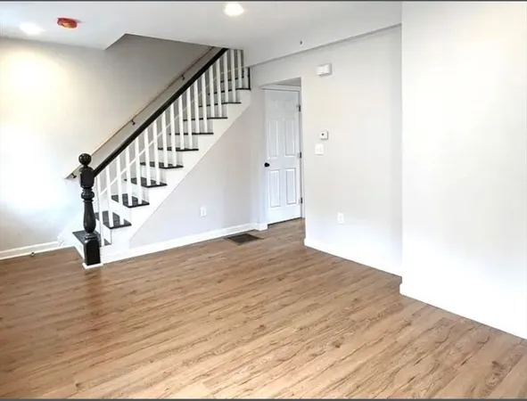 a view of an entryway with wooden floor