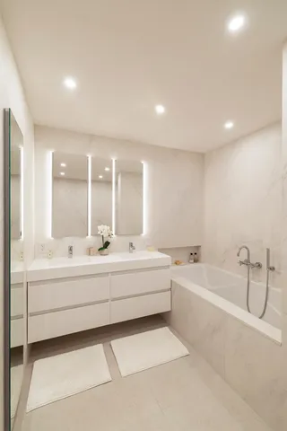 a large white tub sitting in a bathroom