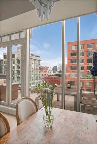 a view of a living room with a large window and table