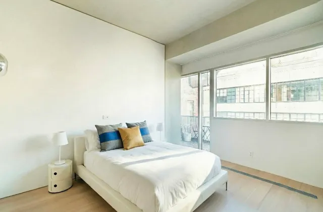 a bedroom with a bed and window