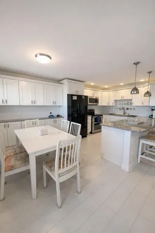a kitchen with a table chairs sink and cabinets