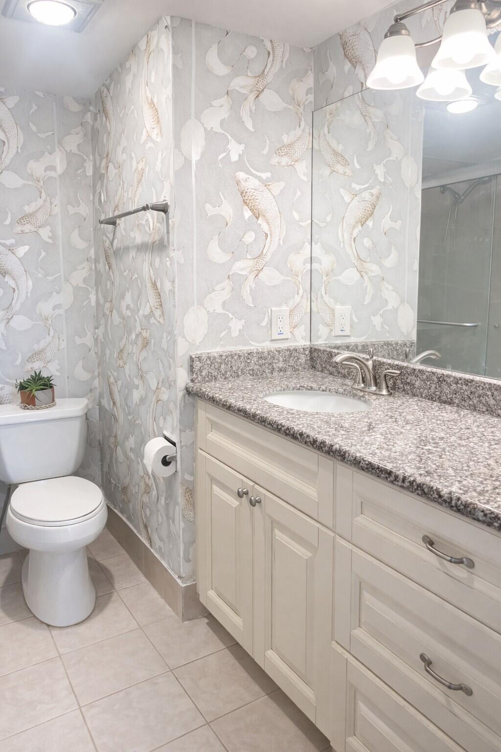 4057 Wolverton C Boca Raton, FL 33434 - Photo 6 of 8 a bathroom with a granite countertop sink a toilet and a shower