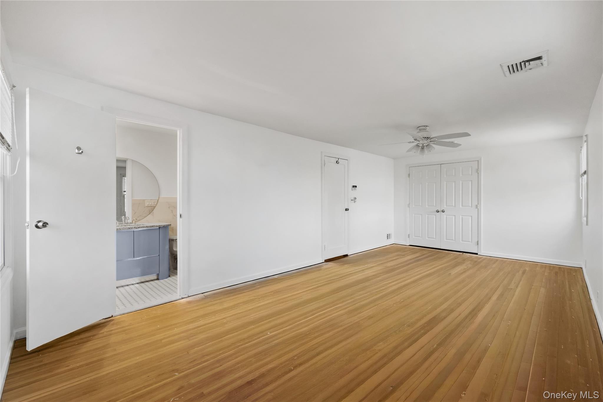 11 Searingtown Road Searingtown, NY 11507 - Photo 20 of 34 an empty room with wooden floor and windows