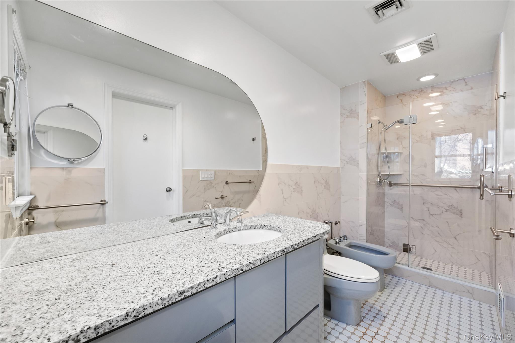 11 Searingtown Road Searingtown, NY 11507 - Photo 21 of 34 a bathroom with a granite countertop sink a toilet and a shower