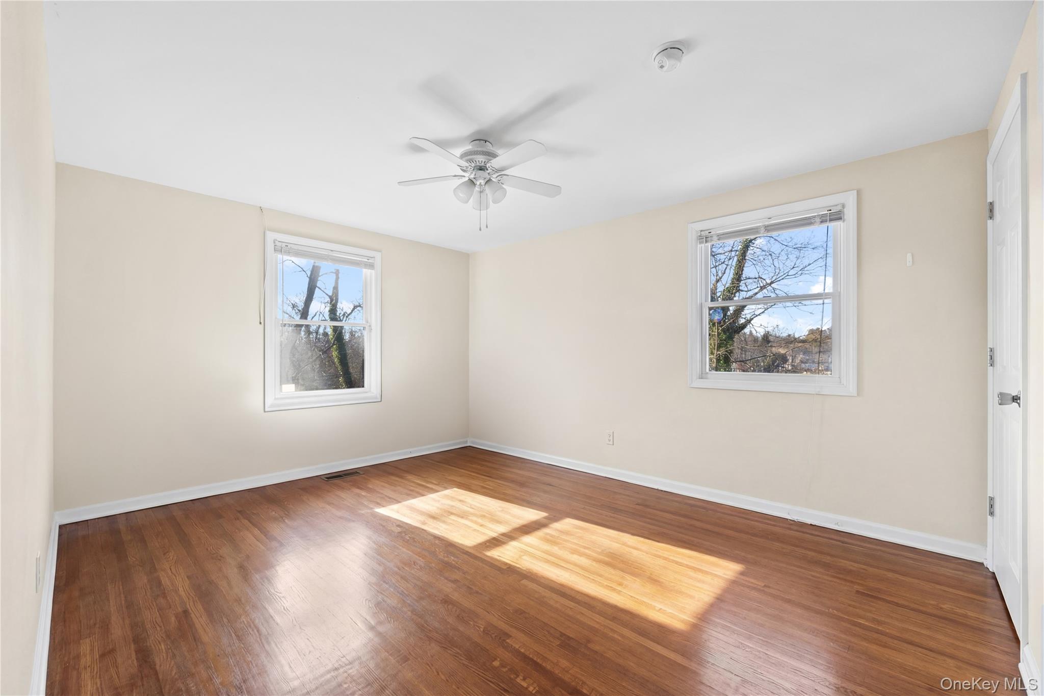 11 Searingtown Road Searingtown, NY 11507 - Photo 24 of 34 a view of empty room with wooden floor and fan