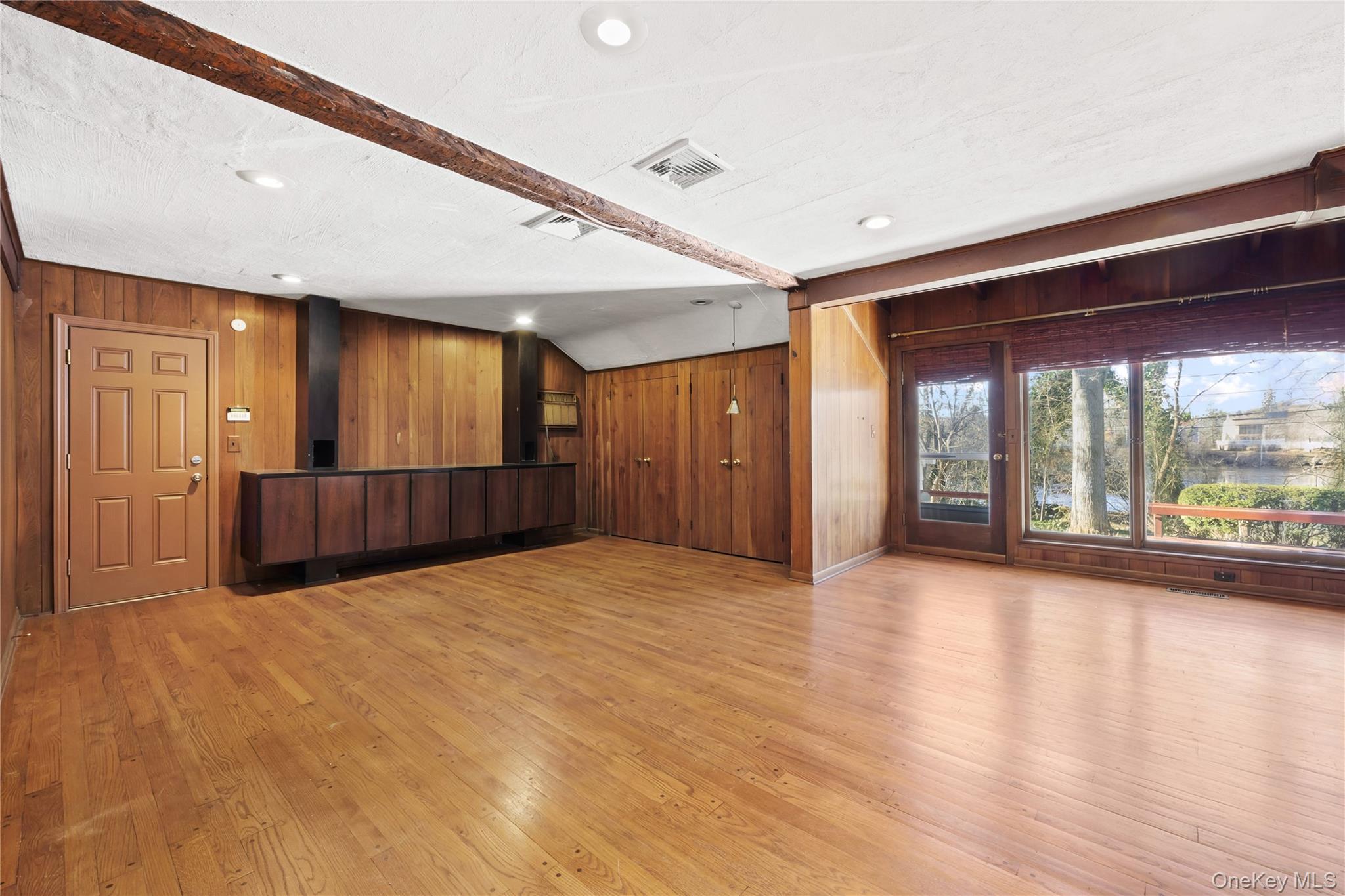 11 Searingtown Road Searingtown, NY 11507 - Photo 5 of 34 a view of an empty room with wooden floor and a window