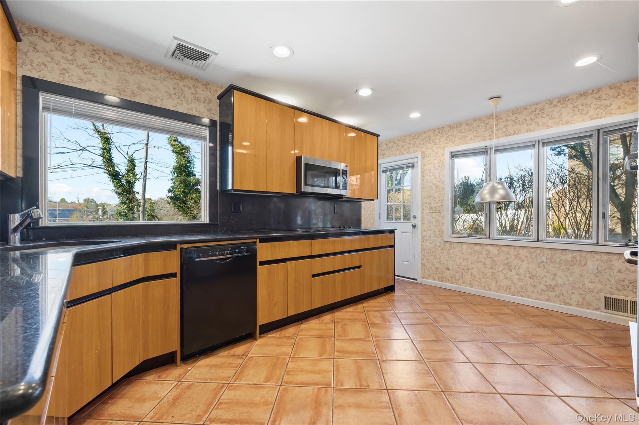 11 Searingtown Road Searingtown, NY 11507 - Photo 7 of 34 a kitchen with stainless steel appliances granite countertop a stove a sink and a microwave