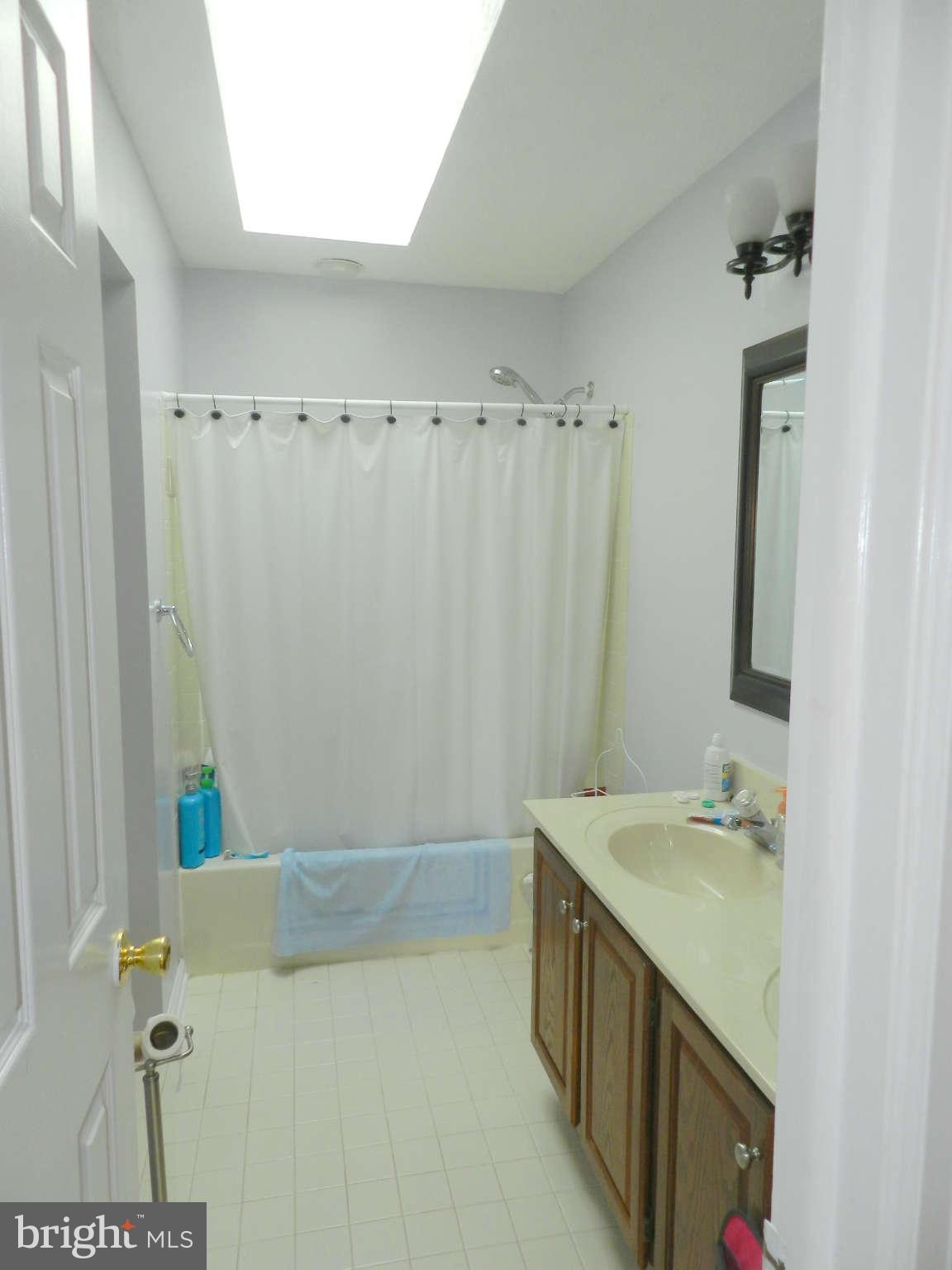 17224 Spates Hill Road Poolesville, MD 20837 - Photo 22 of 30 a bathroom with a double vanity sink and a mirror