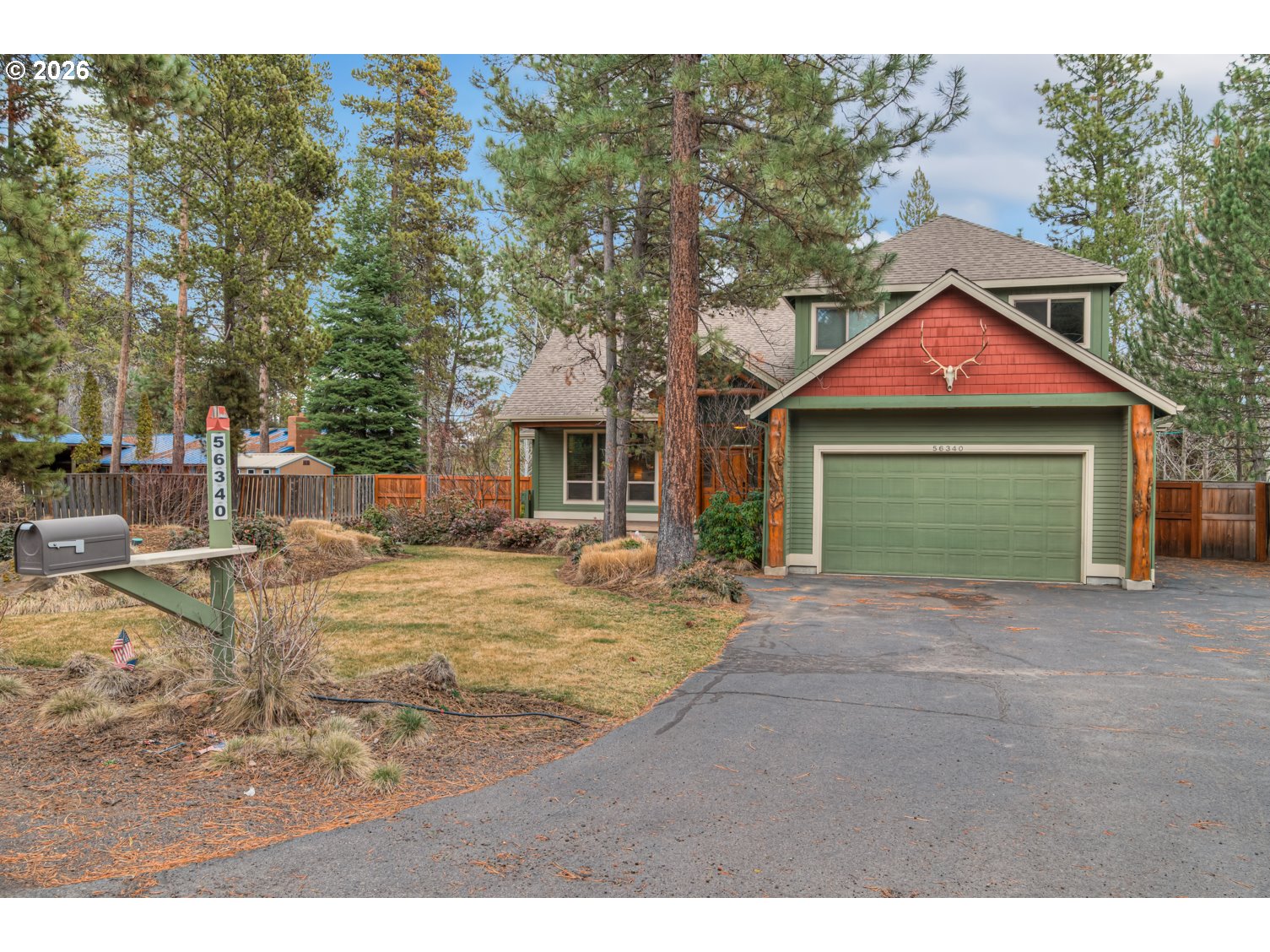 56340 Solar Drive Bend, OR 97707 - Photo 1 of 40 a front view of a house with a yard and garage