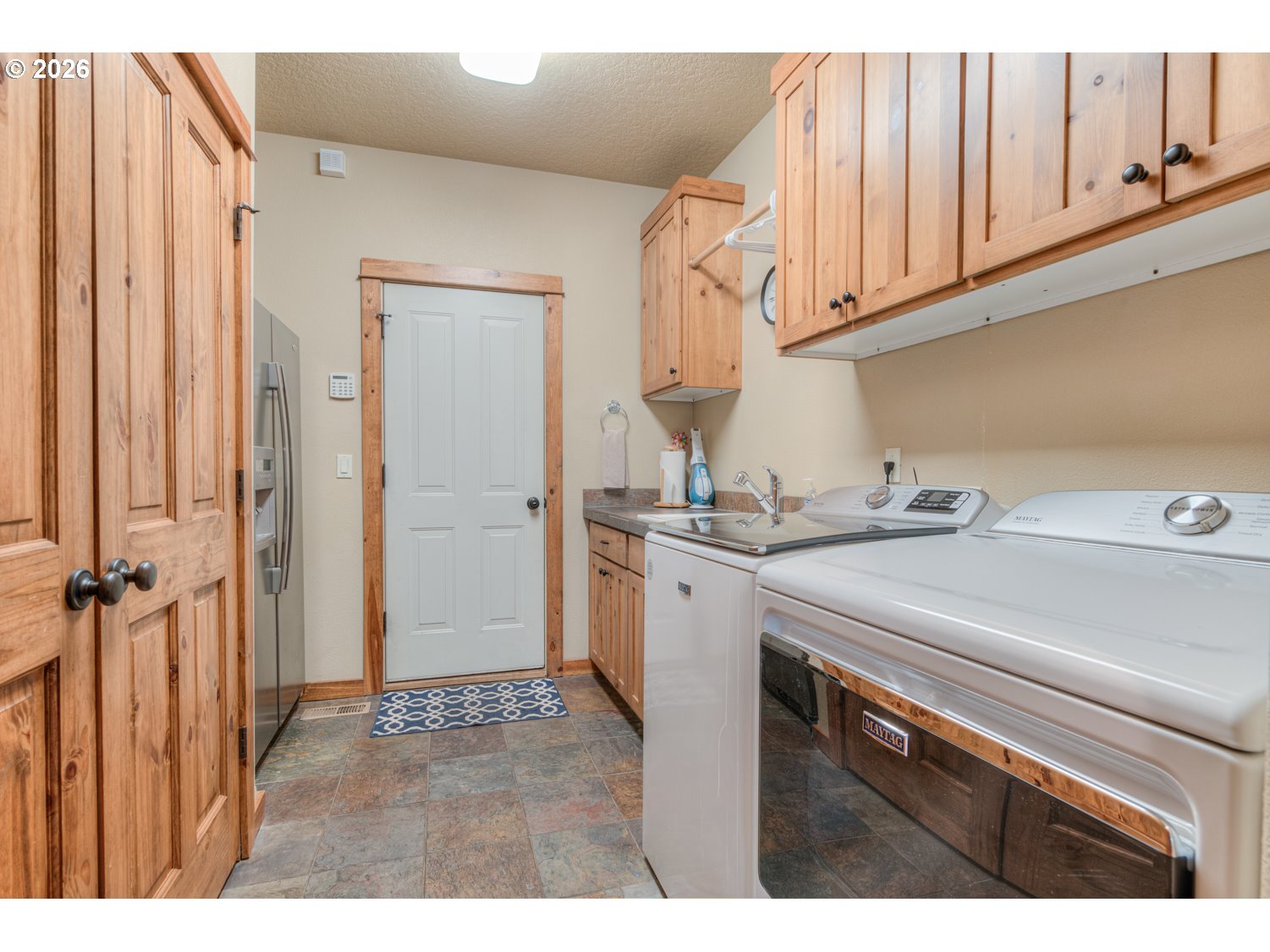56340 Solar Drive Bend, OR 97707 - Photo 18 of 40 a kitchen with a sink and cabinets