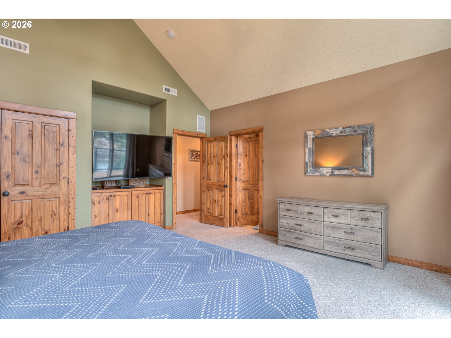 56340 Solar Drive Bend, OR 97707 - Photo 26 of 40 a bedroom with a bed and a television