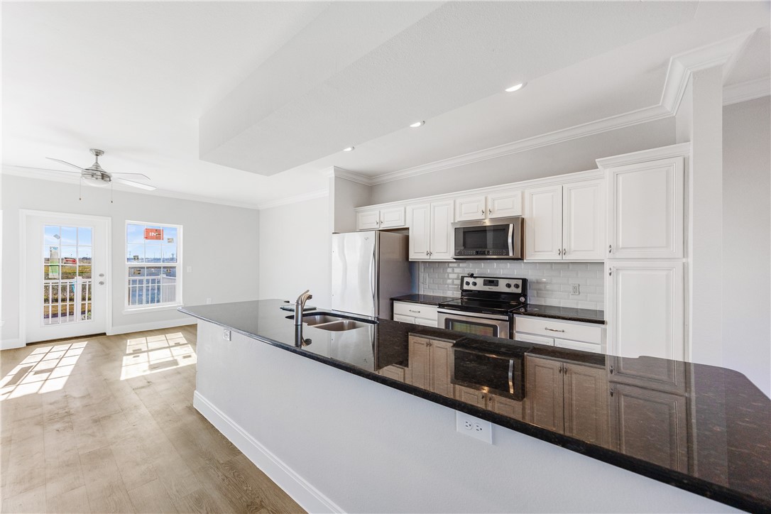 14814 Whitecap Boulevard Corpus Christi, TX 78418 - Photo 11 of 40 a large kitchen with stainless steel appliances granite countertop a lot of counter space and a sink