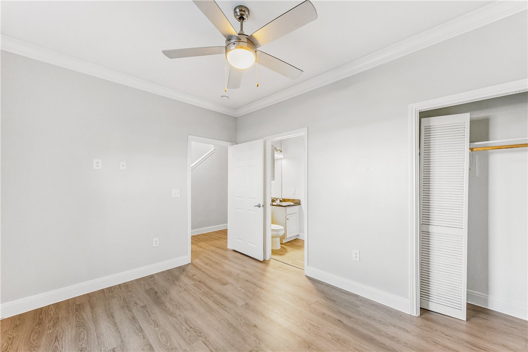 14814 Whitecap Boulevard Corpus Christi, TX 78418 - Photo 17 of 40 an empty room with wooden floor and ceiling fan