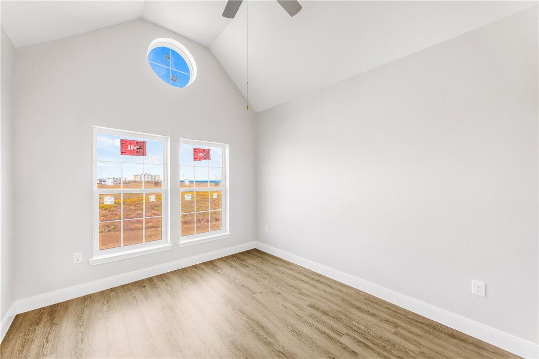 14814 Whitecap Boulevard Corpus Christi, TX 78418 - Photo 20 of 40 a view of an empty room with wooden floor and windows
