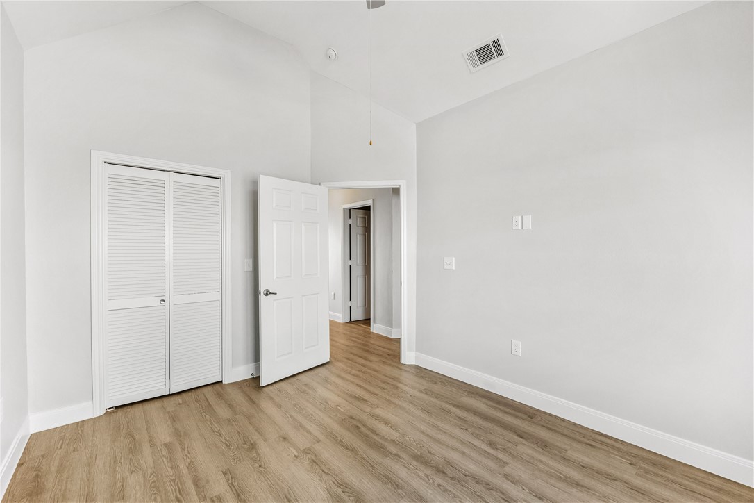 14814 Whitecap Boulevard Corpus Christi, TX 78418 - Photo 21 of 40 a view of an empty room with wooden floor and closet