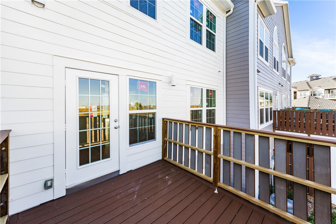 14814 Whitecap Boulevard Corpus Christi, TX 78418 - Photo 33 of 40 a view of a brick house with wooden floor and a large window