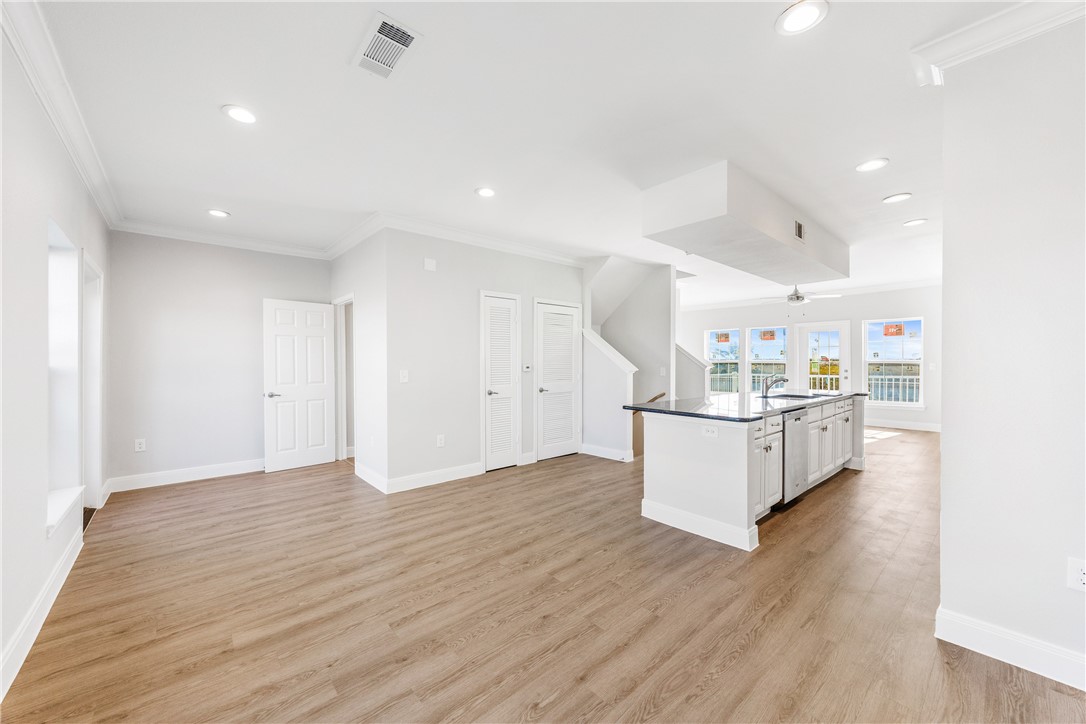 14814 Whitecap Boulevard Corpus Christi, TX 78418 - Photo 8 of 40 a view of kitchen with kitchen island stainless steel appliances cabinets and wooden floor