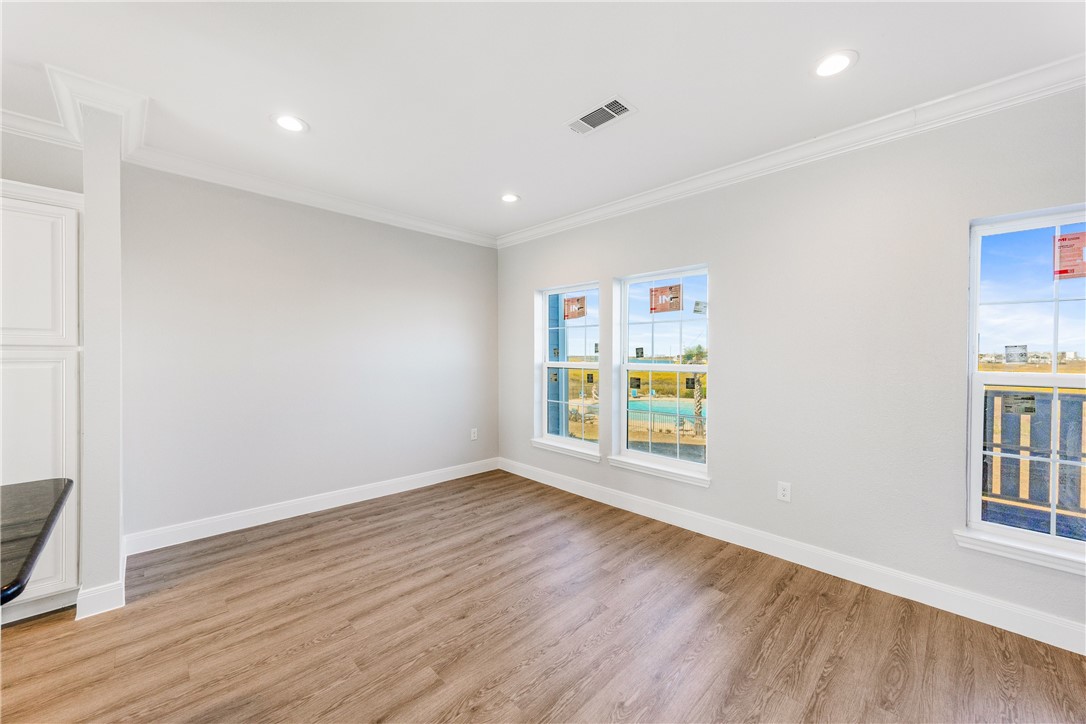 14814 Whitecap Boulevard Corpus Christi, TX 78418 - Photo 10 of 40 a view of an empty room with wooden floor and a window