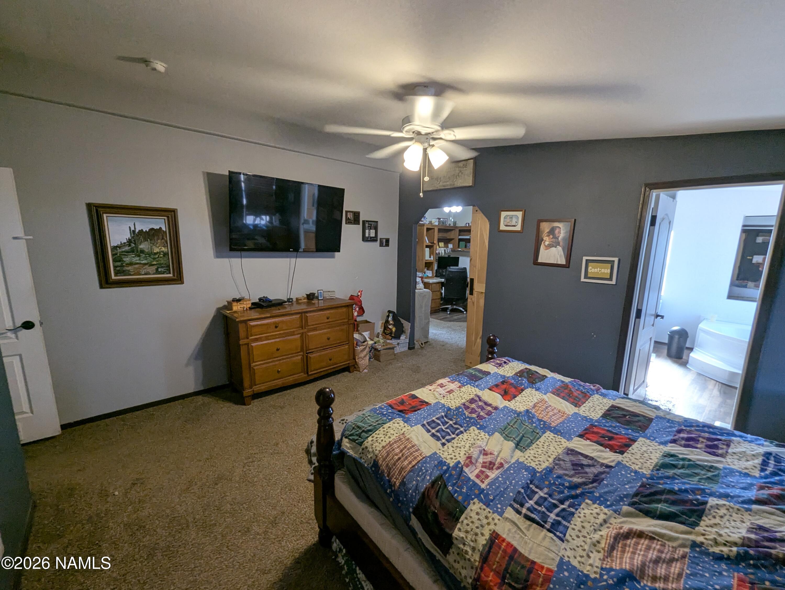 2186 East Clear Point Way Williams, AZ 86046 - Photo 13 of 43 a bedroom with a bed and a flat screen tv
