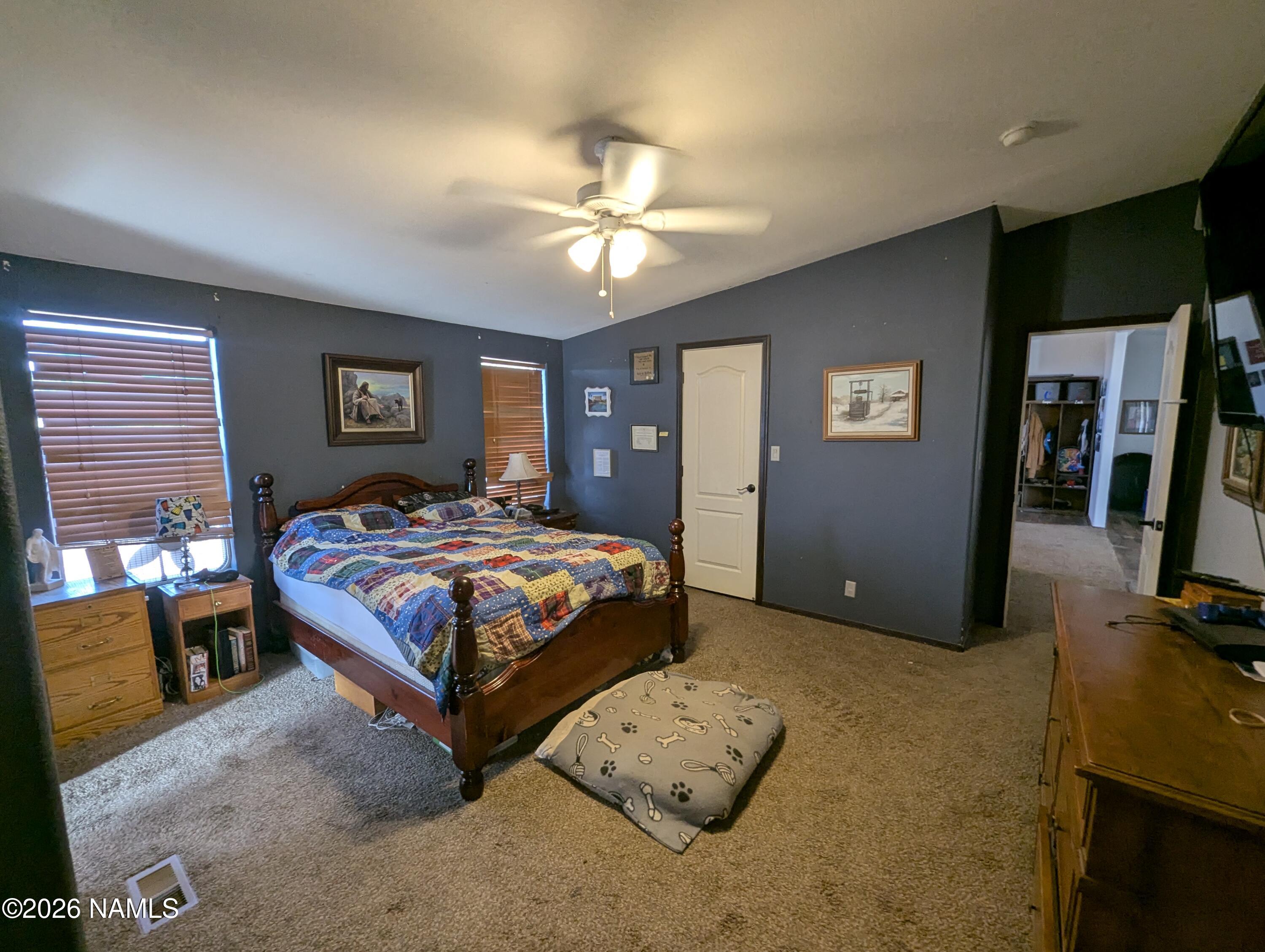 2186 East Clear Point Way Williams, AZ 86046 - Photo 14 of 43 a bedroom with a bed and a flat screen tv
