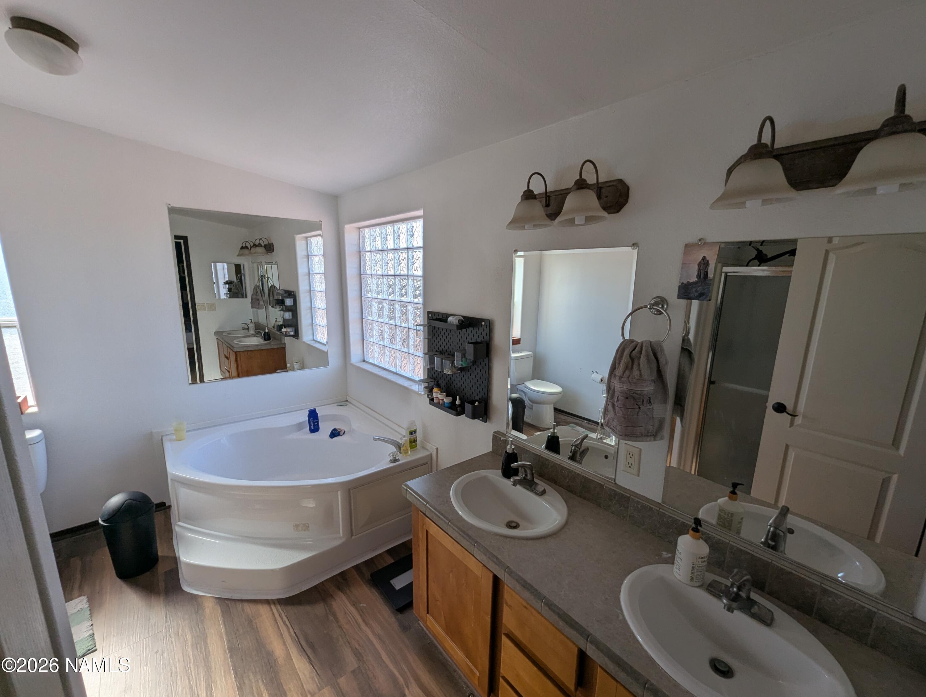 2186 East Clear Point Way Williams, AZ 86046 - Photo 15 of 43 a bathroom with a tub sink and mirror
