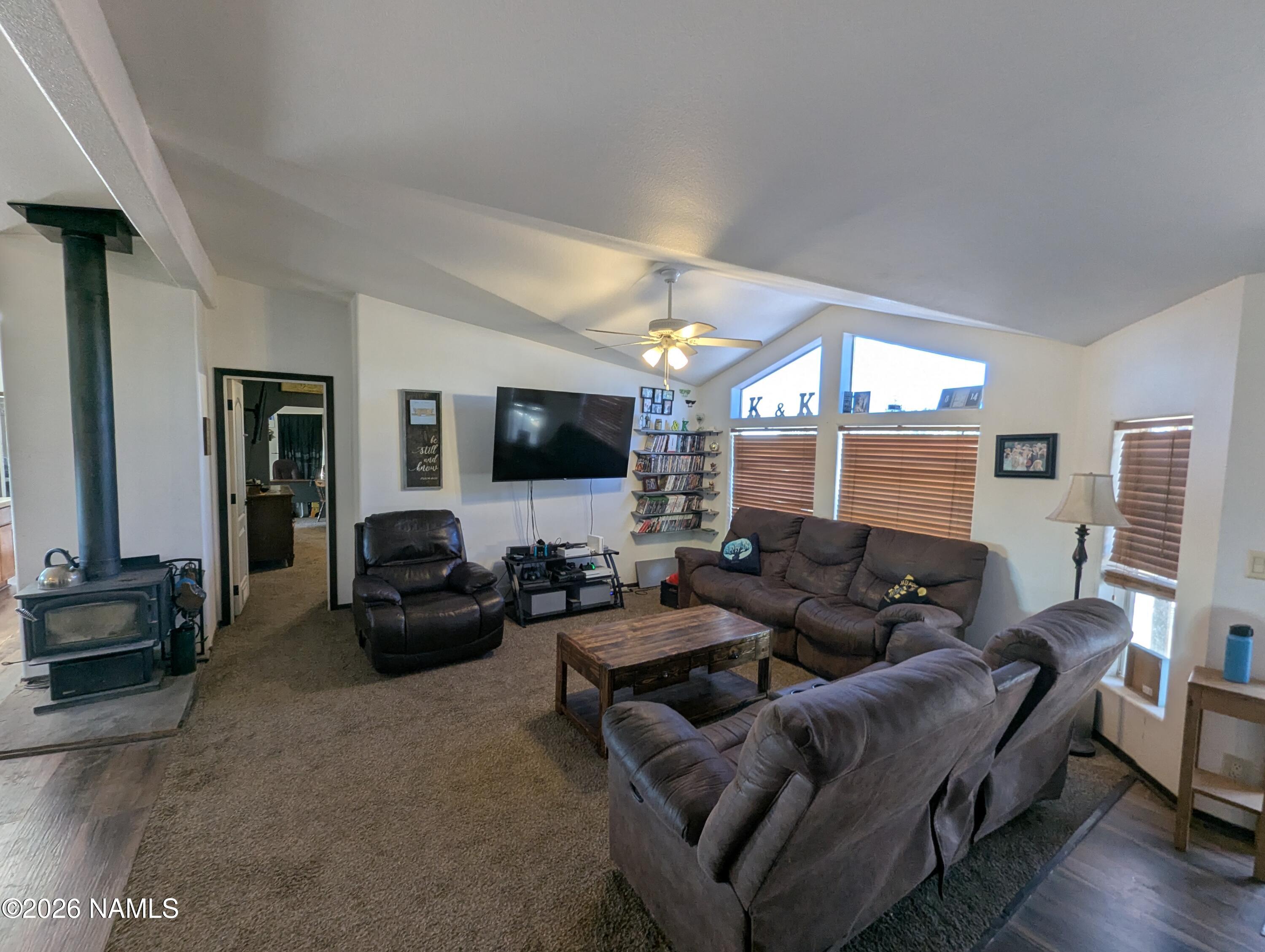 2186 East Clear Point Way Williams, AZ 86046 - Photo 2 of 43 a living room with furniture and a flat screen tv