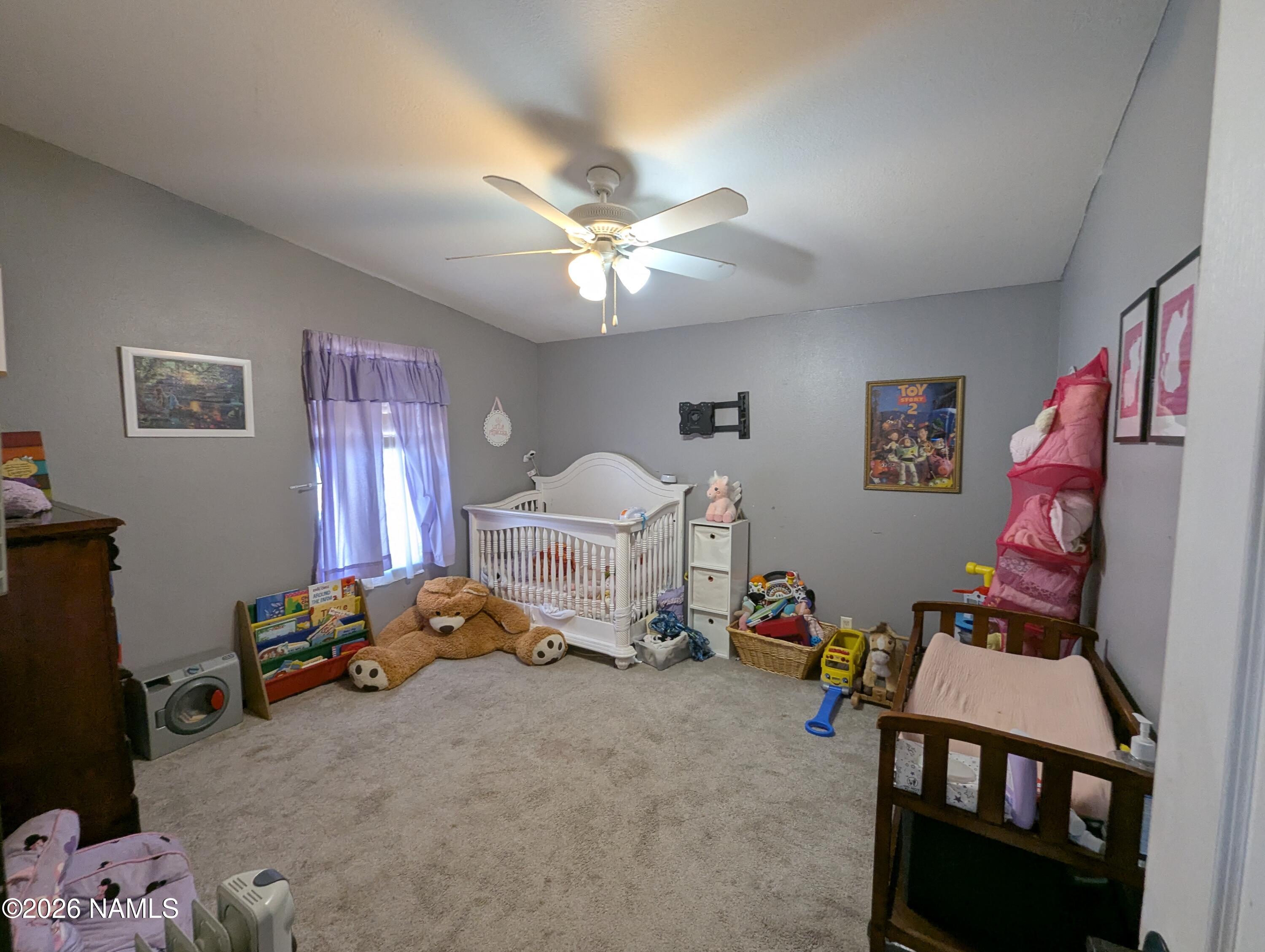 2186 East Clear Point Way Williams, AZ 86046 - Photo 23 of 43 a bedroom with furniture and a chandelier
