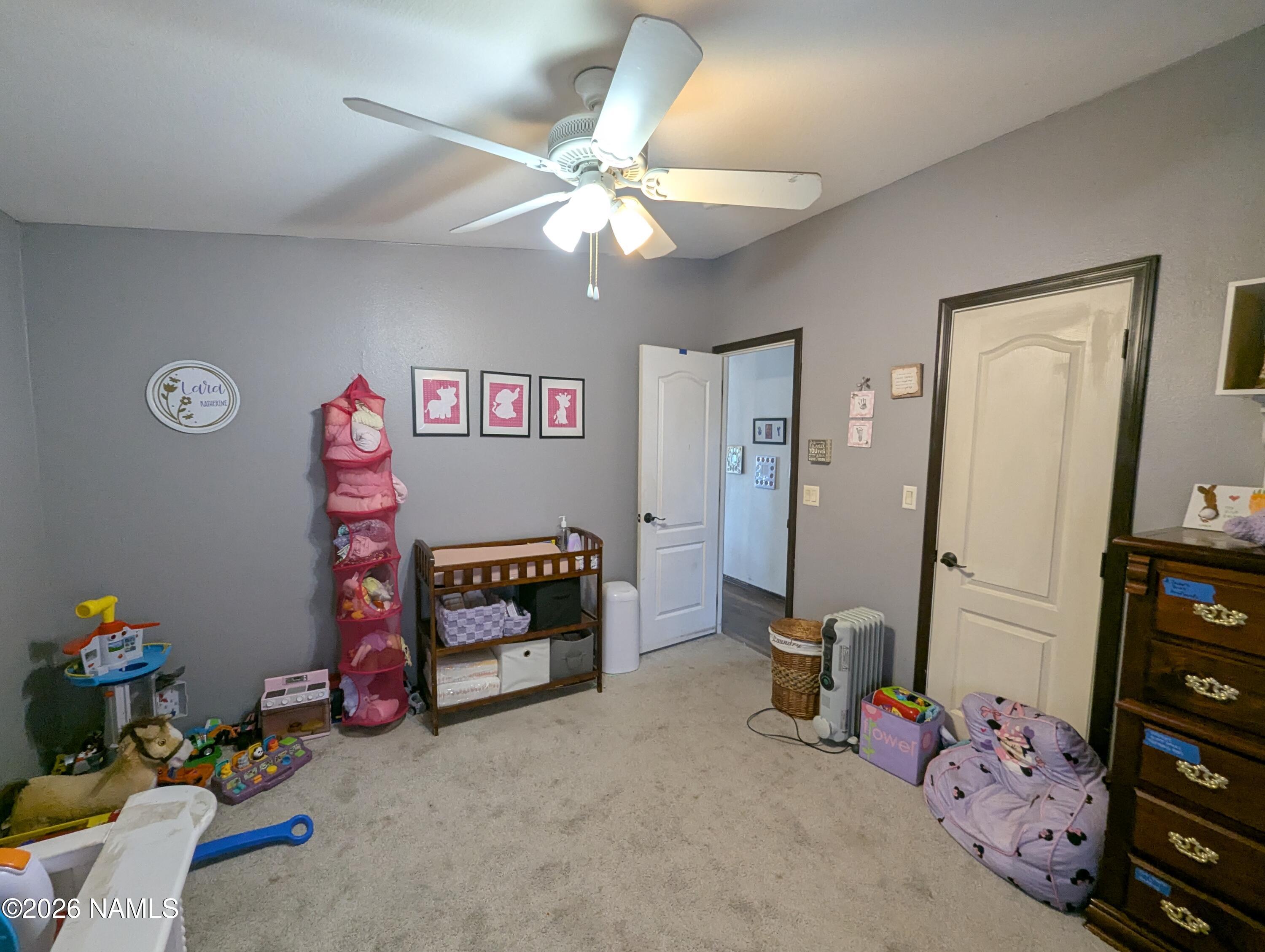 2186 East Clear Point Way Williams, AZ 86046 - Photo 24 of 43 a bedroom with a bed and a chandelier