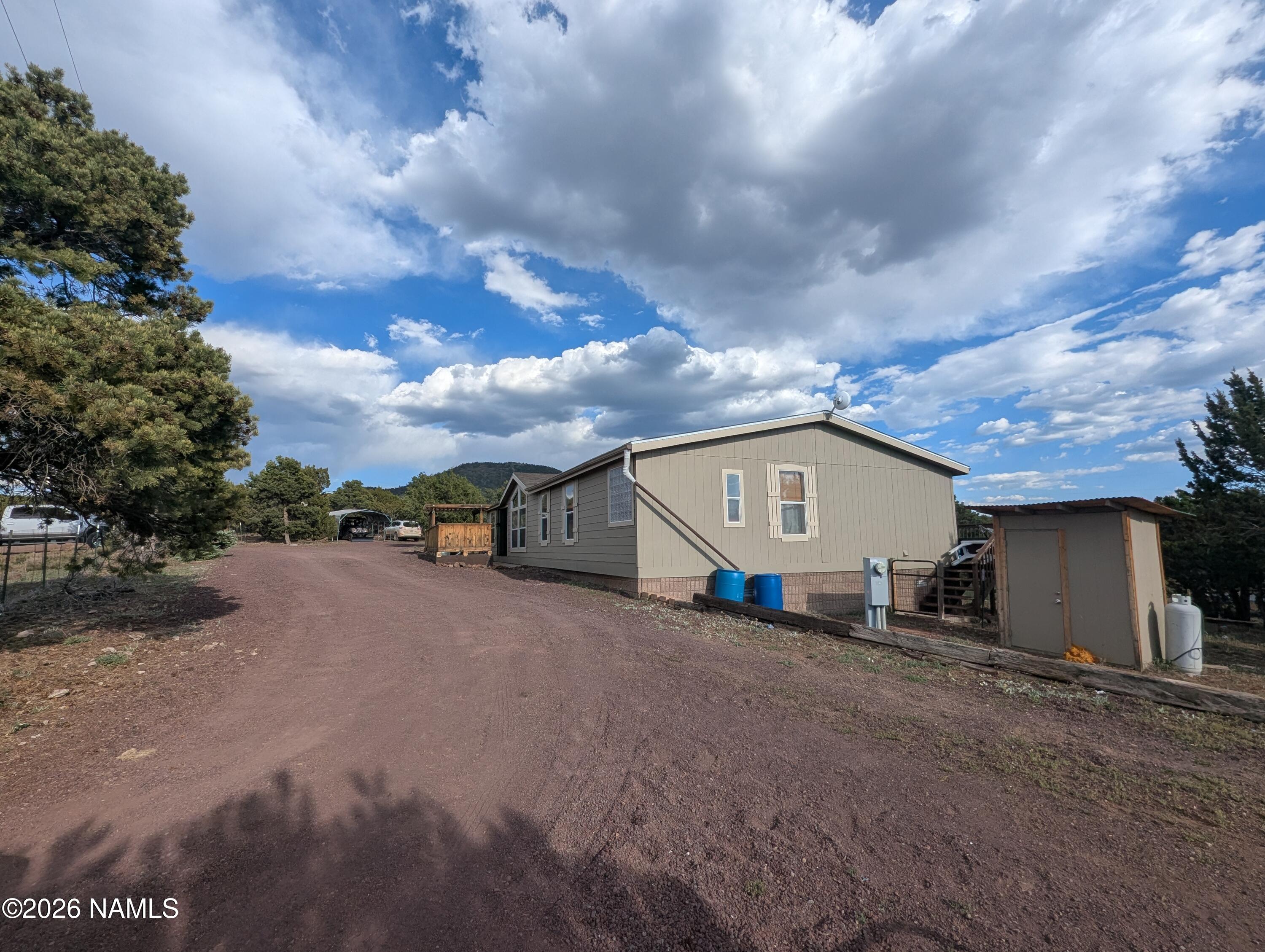 2186 East Clear Point Way Williams, AZ 86046 - Photo 32 of 43 a view of a house with a yard