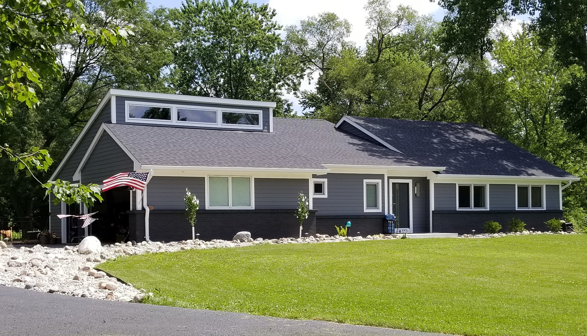 a front view of a house with a garden
