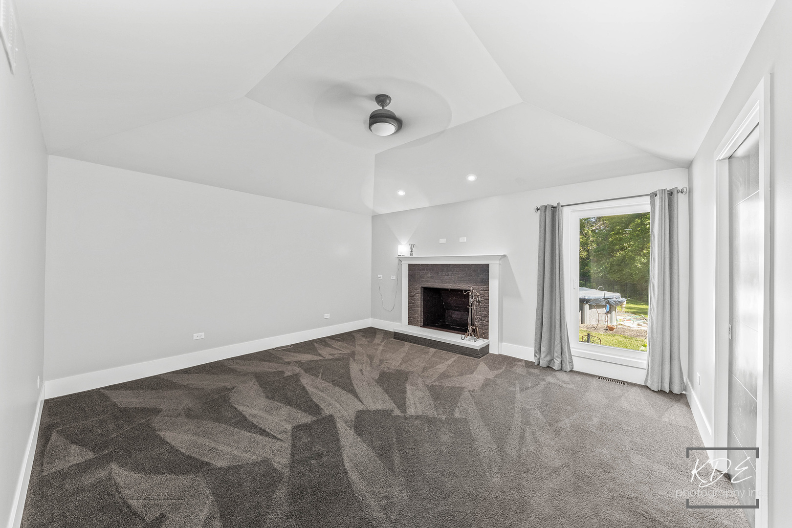 27W320 80th Street Naperville, IL 60565 - Photo 18 of 37 an empty room with floor to ceiling window and a fireplace
