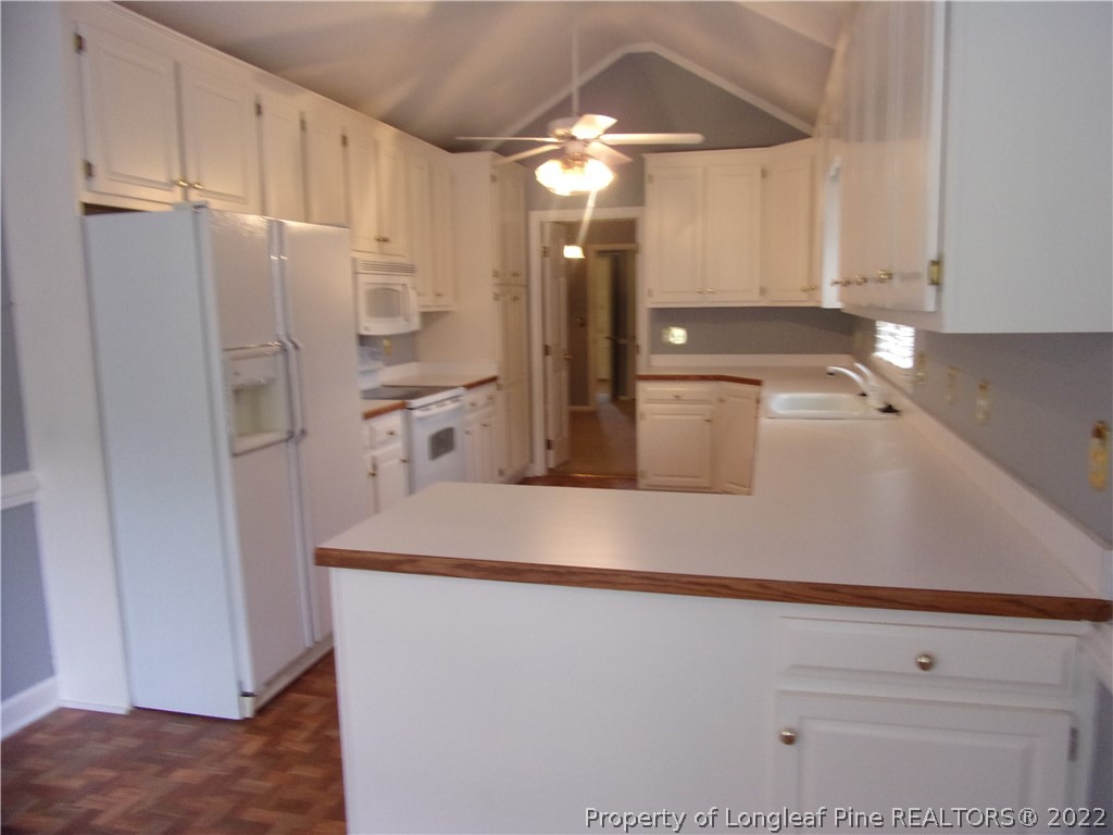 1503 Fairview Street Dunn, NC 28334 - Photo 3 of 10 a kitchen with stainless steel appliances granite countertop a refrigerator and a sink