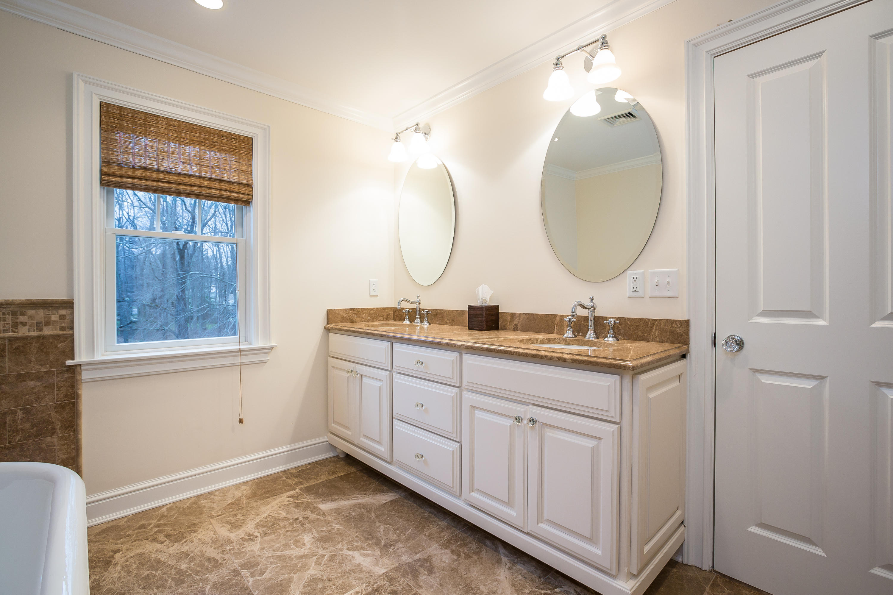 305 Middlesex Road Darien, CT 06820 - Photo 19 of 35 a bathroom with a double vanity sink and a mirror